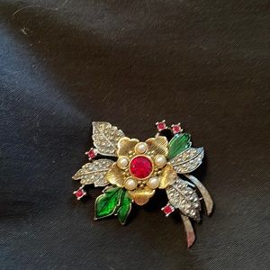 Red green silver and gold brooch.